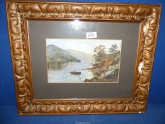 A framed and mounted Watercolour depicting a river landscape with figure in a rowing boat and