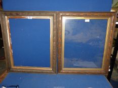 A pair of carved wooden picture frames, one glazed.