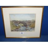 A framed and mounted Watercolour of a rocky stream passing under a stone bridge,