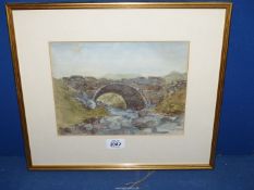 A framed and mounted Watercolour of a rocky stream passing under a stone bridge,