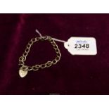 A silver chain bracelet with padlock clasp, hallmark for Birmingham 1976.