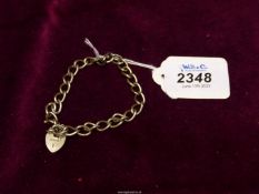 A silver chain bracelet with padlock clasp, hallmark for Birmingham 1976.