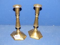 A pair of brass candlesticks with hexagonal bases, 9'' tall.