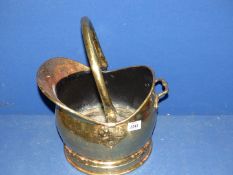 A brass coal scuttle.