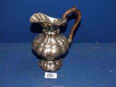 A continental white metal Jug with lobed body, wooden handle, impressed mark to base.