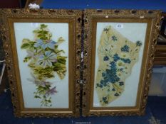 A pair of 19th/20th Century elaborate gilt gesso frames containing Oil paintings of flowers.