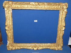 A Victorian gilt gesso frame in the Rocco revival style (needs restoration),