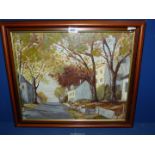 A framed Oil on board of street with trees and houses on both sides, signed lower left Guy Robson,