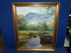 A gilt framed Oil on canvas depicting a river landscape with rugged mountains in the distance,