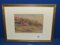 A framed and mounted Watercolour of a beach scene with beached rowing boat and buildings,