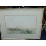 A framed and mounted Watercolour depicting a country landscape with figure sat on a bench with town