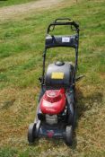 A Honda HRX426 petrol engined lawn mower with grass collector, no fuel cap.