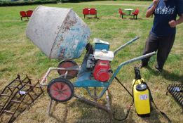 A cement mixer with a Honda engine on a stand [runs,
