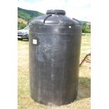 A large black plastic water container [1520 litres]