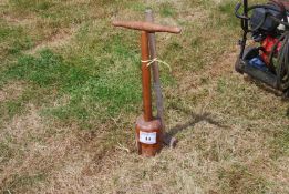 A wooden washing dolly and a sledge hammer.