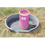 A plastic dog bed and a painted chimney pot.