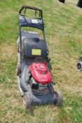 A Honda petrol engined lawn mower, no grass collector. Engine turns - no fuel cap.