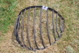 A curved wall-mounting hay rack.