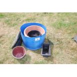 A tub containing plastic garden pots, hanging baskets etc.