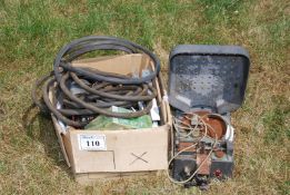 A box of miscellaneous including jump leads, air line hose, exit sign, security camera, turntable,