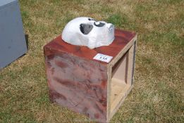 A wooden box / stand with fibre glass skull.