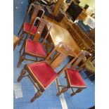 A dark Oak draw leaf dining table with baluster refectory style base and four dining chairs with