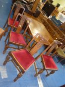 A dark Oak draw leaf dining table with baluster refectory style base and four dining chairs with