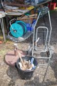 A parasol base, bucket of hammers and a fold up trolley.