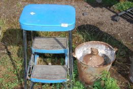 A galvanised pail, small fuel can and a step stool.