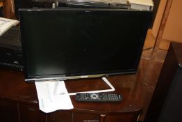 A 24" Philips flat screen TV with remote.