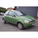 A Ford Ka Style 1,299 cc petrol-engined three-door hatchback motor car in green.