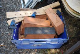 A large container of hardwood blocks, wooden sash clamps.