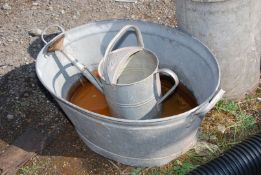 A galvanised bath and 2 1/2 gallon watering can.