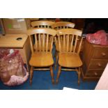 A set of four lathe back kitchen chairs.