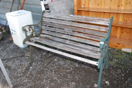 A wooden and cast iron end bench, 50'' wide x 29'' high.
