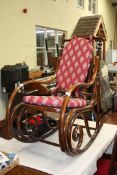 A Bentwood rocking chair with seat and back pad.