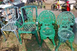 Four cast garden chairs.