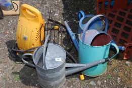 A pressure washer, rack and three watering cans.