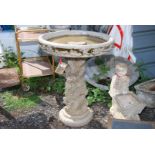 A concrete bird table with grape vine detail, 24'' diameter x 32'' high.