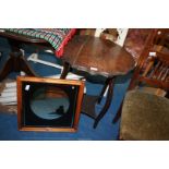 A scalloped edge occasional table with lower shelf and a picture mirror.