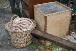 A wood basket, tea chest and rope.