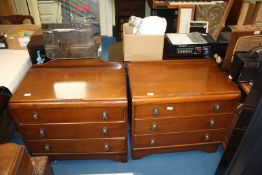 A dressing table with mirror and matching chest of three drawers.