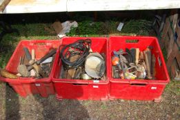 Three red plastic containers containing hammer, masonry kit and various tools.
