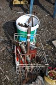 A basket and bucket of grease guns and oil cans.
