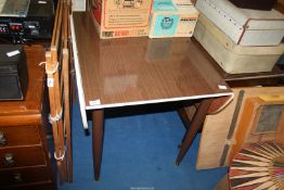 A drop leaf Formica kitchen table.