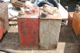 Two Fuel cans (red and green), both with brass caps.