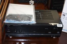 An Eltax Acura Amp - 70 integrated amplifier with remote and manual.