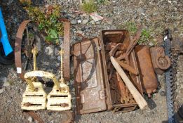 A military box of old tools, hammer, weight, metal lifting irons and part of an old cultivator.