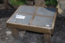 A low slate top wooden table, 25'' x 21'' x 12'' high.