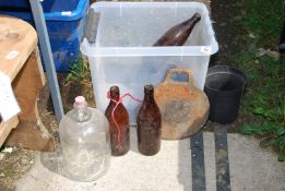 Old cider bottles, pair of large gate hinges, demi-john and griddle.